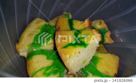 Close up shot of green patterned sponge cake that has been cut. 141826066