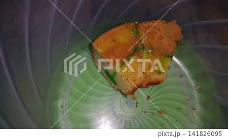 Shot of a green patterned chiffon cake that has been cut. Only 2 left. Shot of a green patterned chiffon cake that has been cut. Only 2 left. 141826095