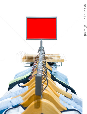 Empty red rectangular promotional display sign mockup over a clothing rack in a shop 141826350