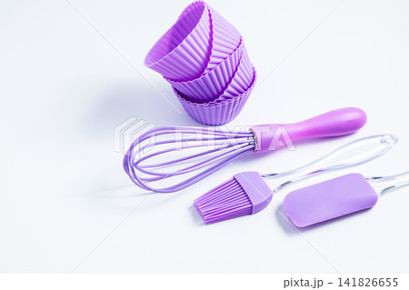 Baking tools on a white surface for creating desserts and pastries in a kitchen setting Baking tools on a white surface for creating desserts and pastries in a kitchen setting 141826655
