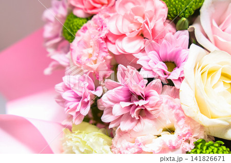 Bouquet with pink flowers chrysanthemums and greenery for a special occasion in a bright space Bouquet with pink flowers chrysanthemums and greenery for a special occasion in a bright space 141826671