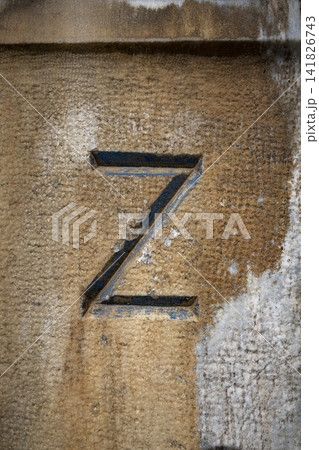 Letter Z carved into stone wall with weathered texture 141826743