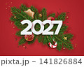 White 2027 numbers surrounded by fir branches, gingerbread and candy cane on red background 141826884