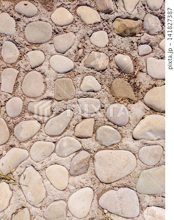 Round stones arranged on dry sandy ground Round stones arranged on dry sandy ground 141827387
