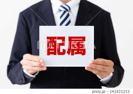配属のホワイトボードを持つリクルートスーツを着た若い男性ビジネスマン 141831253