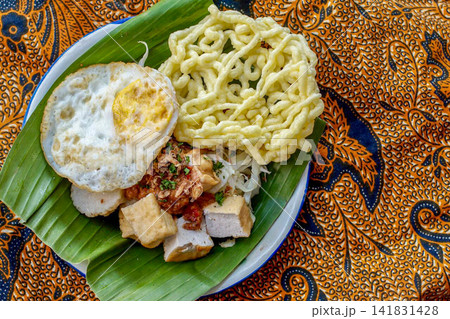 Traditional Indonesian Tahu Campur with Fried Egg and Crackers Traditional Indonesian Tahu Campur with Fried Egg and Crackers 141831428