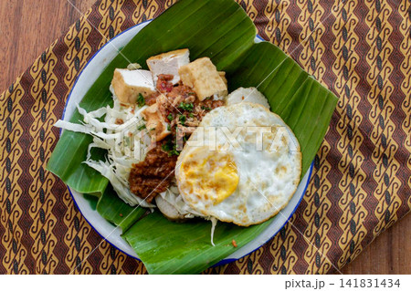Traditional Indonesian Tahu Campur with Fried Egg and Crackers Traditional Indonesian Tahu Campur with Fried Egg and Crackers 141831434