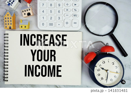 Increase Your Income text written on notepad with house model, calculator, magnifying glass and alarm clock on marble background 141831481