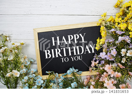 "Happy Birthday To You" Message on Chalkboard Surrounded by Colorful Flowers "Happy Birthday To You" Message on Chalkboard Surrounded by Colorful Flowers 141831653