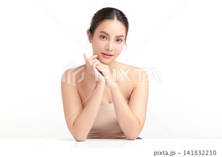 A beautiful young Asian woman with clean, fresh skin against a white background. Skincare, facial treatment, cosmetology, beauty, and spa. An elegant portrait of an Asian woman. 141832210