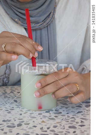 Drinking a cold beverage at a cafe 141835405