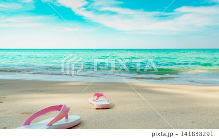 Pink and white sandals on sand beach. Casual style flip-flop were removed at seaside. Summer vacation on tropical beach. Fun holiday travel on sandy beach. Summertime. Summer vibes. Relaxing time. Pink and white sandals on sand beach. Casual style flip-flop were removed at seaside. Summer vacation on tropical beach. Fun holiday travel on sandy beach. Summertime. Summer vibes. Relaxing time. 141838291