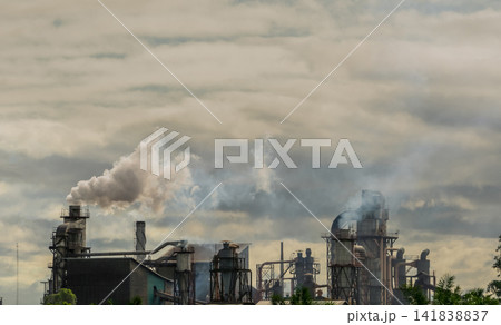 CO2 emissions. CO2 greenhouse gas emissions from factory chimneys. Carbon dioxide gas global air climate pollution. Carbon dioxide in earths atmosphere. Greenhouse gas. Smoke emissions from chimneys. 141838837
