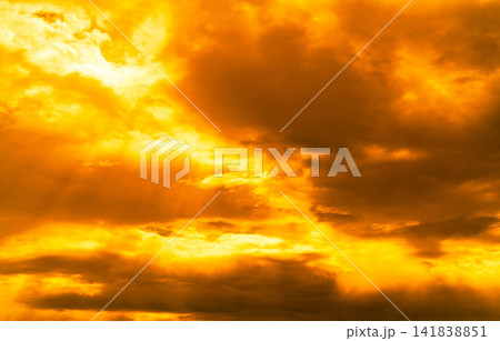 God light. Dramatic golden cloudy sky with sun beam. Yellow sun rays through  golden clouds. God light from heaven for hope and faithful concept. Believe in god. Beautiful sunlight sky background. 141838851