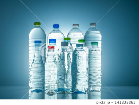 Set of transparent plastic water bottle with blank label. Clear water and natural mineral bottle with white, green, red, and blue cap. Healthy drink. Collection of plastic bottle with full liquid. 141838863