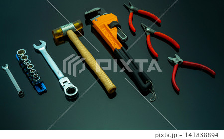Set of mechanic tools on black background. Chrome wrenches or spanners, hexagon socket, end cutter pliers, locking pliers, pincers, plastic hammer, monkey pipe wrench. Chrome vanadium spanner wrench. Set of mechanic tools on black background. Chrome wrenches or spanners, hexagon socket, end cutter pliers, locking pliers, pincers, plastic hammer, monkey pipe wrench. Chrome vanadium spanner wrench. 141838894