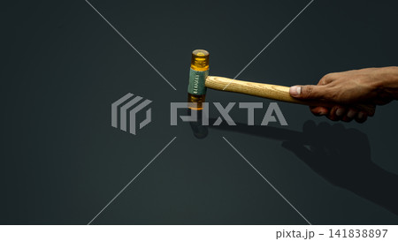 Man's hand holding plastic hammer isolated on dark background. Male worker's hand hold wood handle of plastic hammer. Hammer head made of soft and tough yellow plastic that not damage workpiece. Man's hand holding plastic hammer isolated on dark background. Male worker's hand hold wood handle of plastic hammer. Hammer head made of soft and tough yellow plastic that not damage workpiece. 141838897