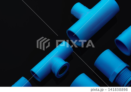 Set of blue PVC pipe fittings isolated on dark background. Blue plastic water pipe. PVC accessories for plumbing. Plumber equipment. Bend and three way connection plastic pipe for water drain sewage. Set of blue PVC pipe fittings isolated on dark background. Blue plastic water pipe. PVC accessories for plumbing. Plumber equipment. Bend and three way connection plastic pipe for water drain sewage. 141838898