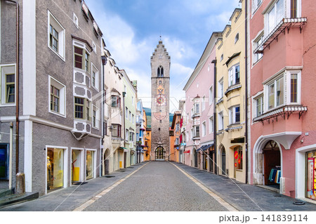 Quiet cobblestone street leading to clock tower in Italian historic town Vipiteno Sterzing 141839114