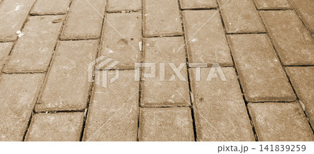 Sepia-brown brick paving texture with a running bond pattern. 141839259