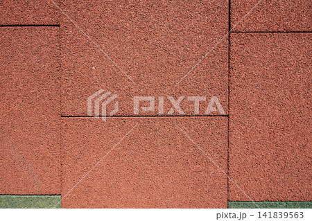 Aesthetic diagonal background of textured outdoor red rubber mat pavement, perfect for architectural 141839563