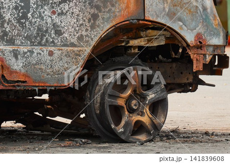 Melted Exploded Car Tire and Charred Wheel Rim Detail Melted Exploded Car Tire and Charred Wheel Rim Detail 141839608