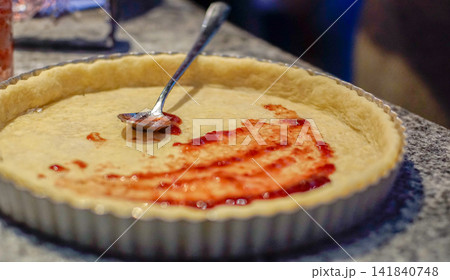 Strawberry Jam Spread on Unbaked Pastry Tart Shell During Baking Preparation Strawberry Jam Spread on Unbaked Pastry Tart Shell During Baking Preparation 141840748