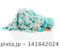 Side view horizontal portrait of cute young Asian Muslim girl performing Sujud prostration isolated on white background. 141842024