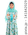 Half length portrait of confident young Asian Muslim girl crossing arms isolated on white background. 141842029