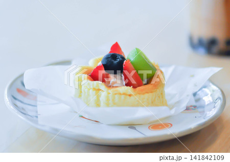 cheesecake with fruit topping or basque cheesecake with fruit topping, piece of cake cheesecake with fruit topping or basque cheesecake with fruit topping, piece of cake 141842109