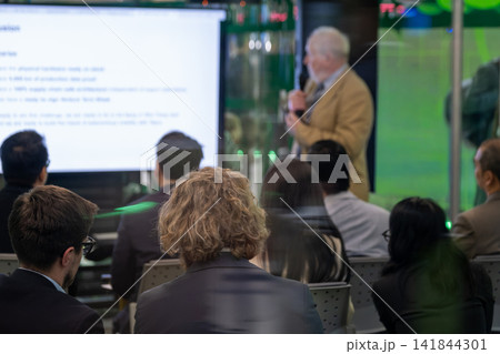 Senior speaker leads presentation for seated audience Senior speaker leads presentation for seated audience 141844301