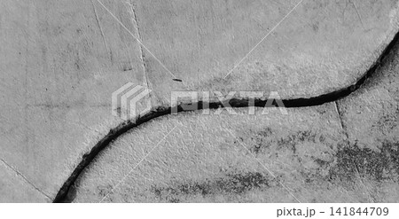 Monochrome cracked concrete wall with a grunge effect and curved lines. Monochrome cracked concrete wall with a grunge effect and curved lines. 141844709
