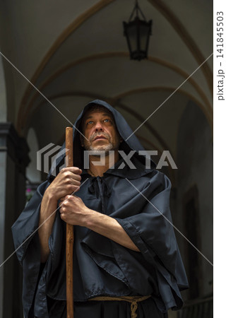Historical image of a monk in period costume with hood. Historical image of a monk in period costume with hood. 141845503