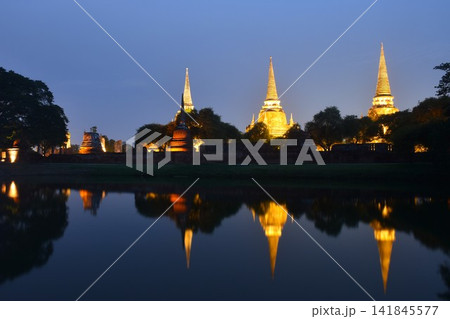 pagoda of Wat Phra Si Sanphet or temple of the holy, splendid Omniscient reflection on water with electric lamp in night pagoda of Wat Phra Si Sanphet or temple of the holy, splendid Omniscient reflection on water with electric lamp in night 141845577