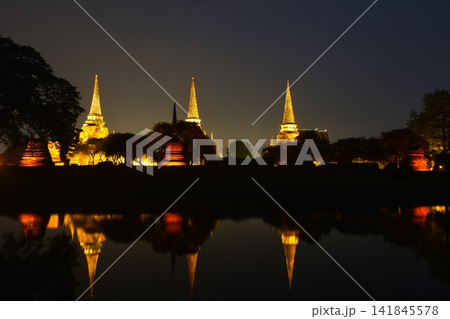 pagoda of Wat Phra Si Sanphet or temple of the holy, splendid Omniscient reflection on water with electric lamp in night pagoda of Wat Phra Si Sanphet or temple of the holy, splendid Omniscient reflection on water with electric lamp in night 141845578