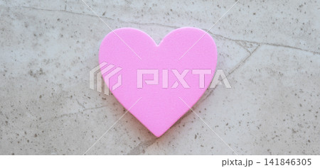 Fabric pink heart on the stone table background. Concept with love sign for card and Valentines day. Fabric pink heart on the stone table background. Concept with love sign for card and Valentines day. 141846305