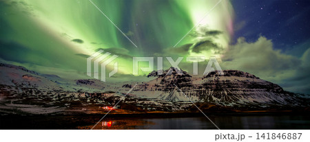 Northern Lights Over Snowy Mountains and Arctic Lake at Night 141846887