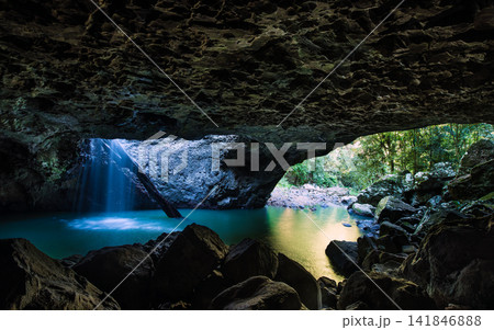 Cave Waterfall with Turquoise Pool in Tropical Forest 141846888
