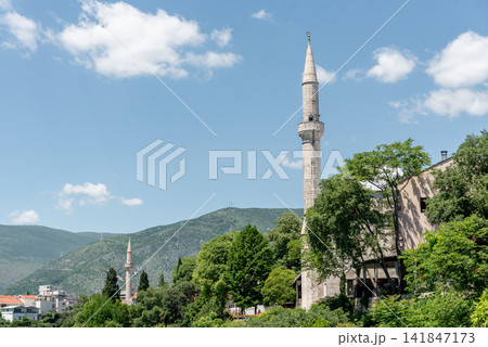 Islamic mosque temple in city Mostar in Bosnia and Herzegovina, mountain view 141847173