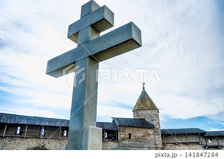 Orthodox religious Christian large stone cross is installed outside church Orthodox religious Christian large stone cross is installed outside church 141847284