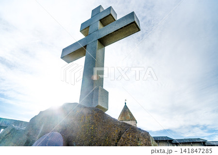 Orthodox religious Christian large stone cross is installed outside church Orthodox religious Christian large stone cross is installed outside church 141847285