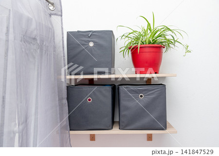 Gray square boxes for organizing space and storing things on shelf bedroom Gray square boxes for organizing space and storing things on shelf bedroom 141847529