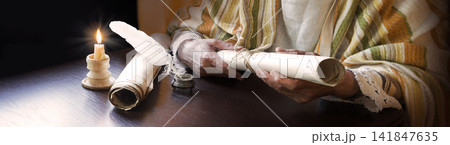 Man holding an old scroll Man holding an old scroll 141847635