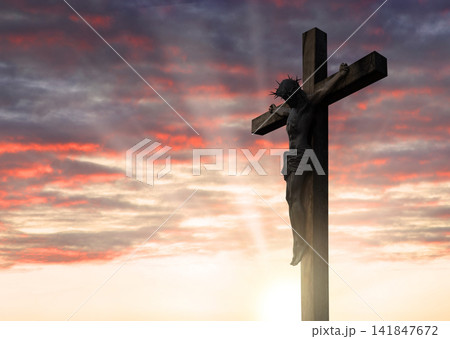 Crucified Christ hangs on the cross 141847672