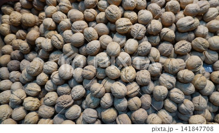 Close-up walnuts highlight rough shells and earthy tones, organic food concept Close-up walnuts highlight rough shells and earthy tones, organic food concept 141847708