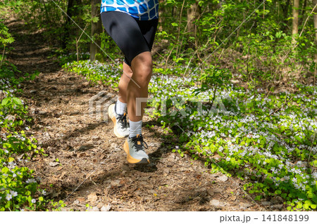 Close-up of a runners legs in white sneakers Close-up of a runners legs in white sneakers 141848199