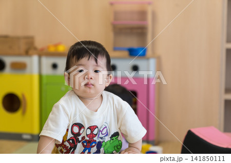 キッズルームでおもちゃを持ち遊ぶ日本人の男の赤ちゃん キッズルームでおもちゃを持ち遊ぶ日本人の男の赤ちゃん 141850111