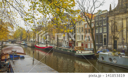 Autumn canals of Amsterdam with houseboats and Dutch houses, panoramic view with copy space Autumn canals of Amsterdam with houseboats and Dutch houses, panoramic view with copy space 141853819