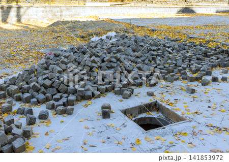 Construction work in progress with stone blocks scattered on ground at building site Construction work in progress with stone blocks scattered on ground at building site 141853972
