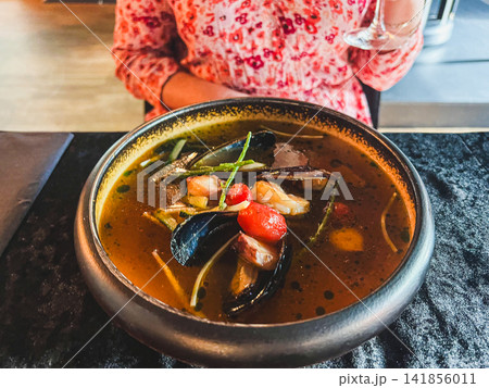 Gourmet Seafood Soup with Mussels Prawns and Tomatoes Served in Ceramic Bowl Gourmet Seafood Soup with Mussels Prawns and Tomatoes Served in Ceramic Bowl 141856011